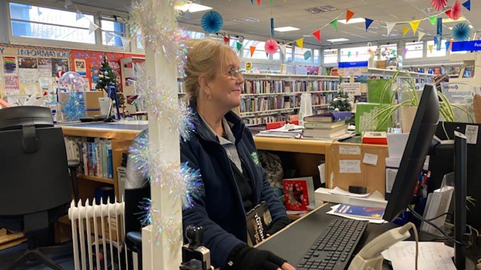 Staff member inside Greenwood Library