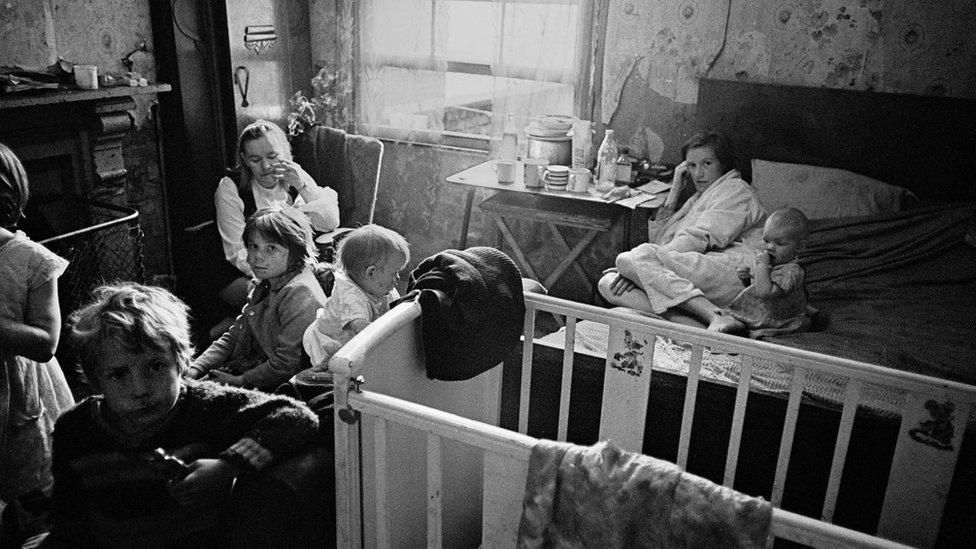 Family living in a single room Moss Side, 1969