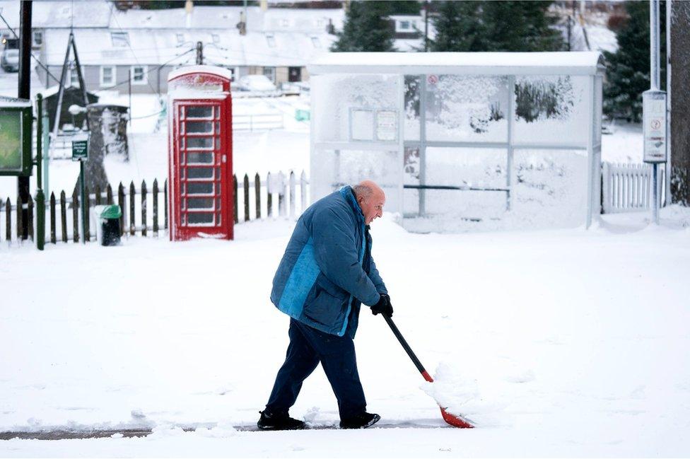 Man clearing snow in Leadhills