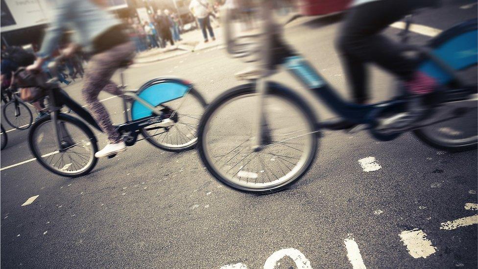 people riding bicycles on city street