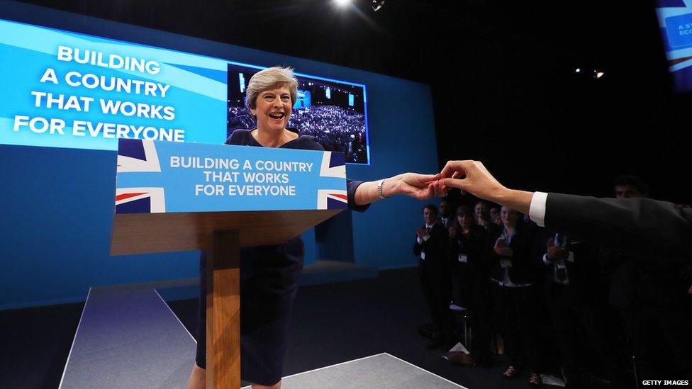 PM Theresa May is handed a cough sweet