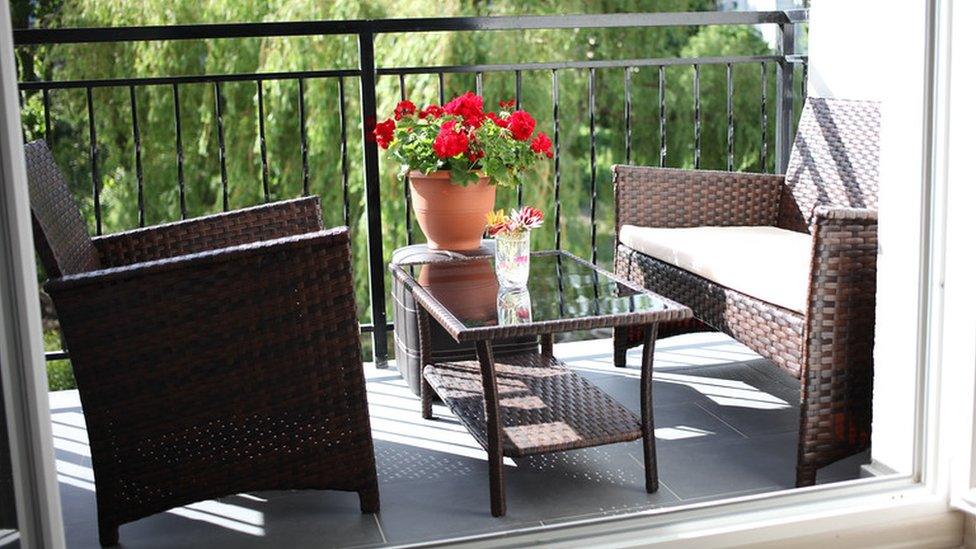 Shot of two chairs and table on a flat balcony