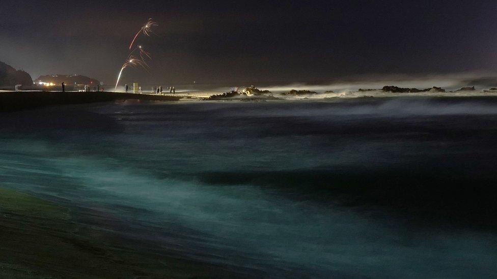 Revellers launch fireworks from Jeongdongjin beach in Gangneung, Ganwon-province, South Korea