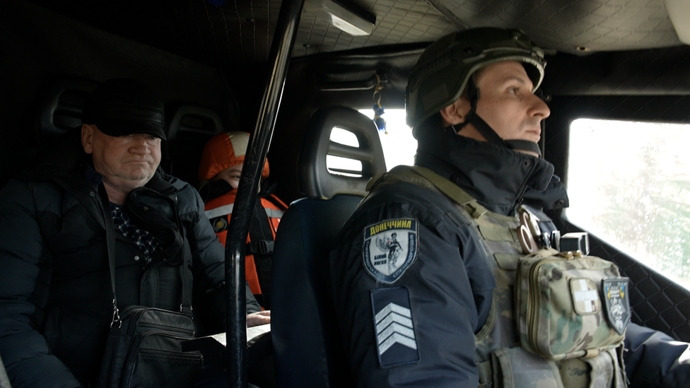 Valeriy (left) and his grandson are evacuated from Donetsk