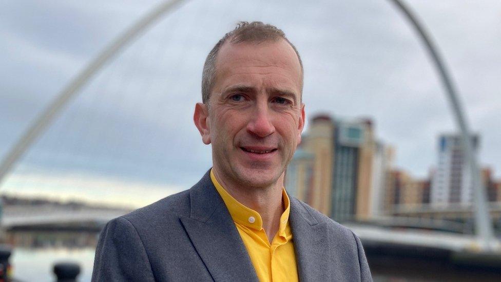 Dr Aidan King standing on Newcastle's Quayside