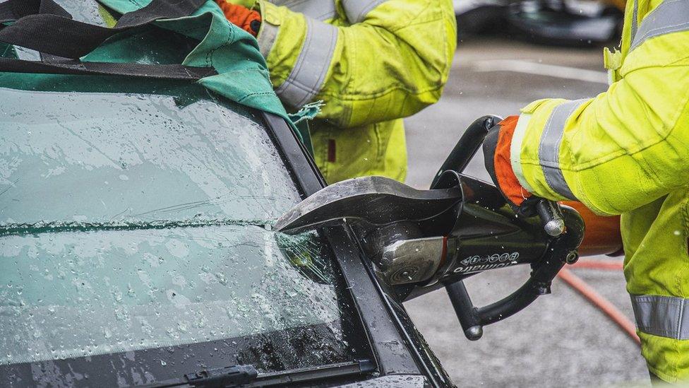 Firefighters cutting car windscreen