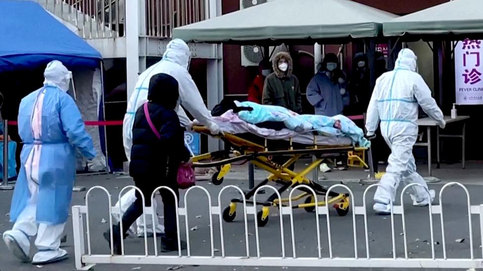 Medical staff moves a patient into a fever clinic at Chaoyang Hospital in Beijing, China, on 13 December 2022