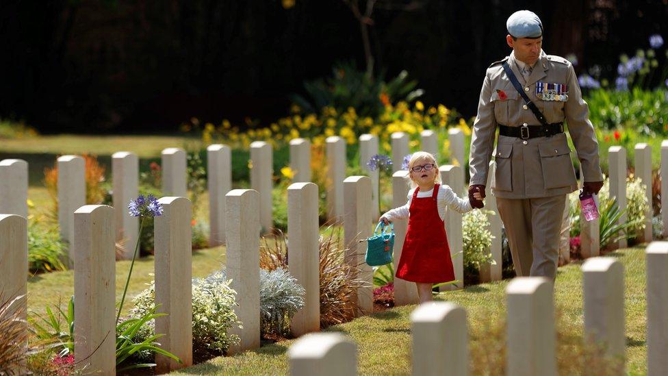 In Kenya, serviceman Ed Watters of the Royal Electrical and Mechanical Engineers walked among graves with his daughter Jocelyn