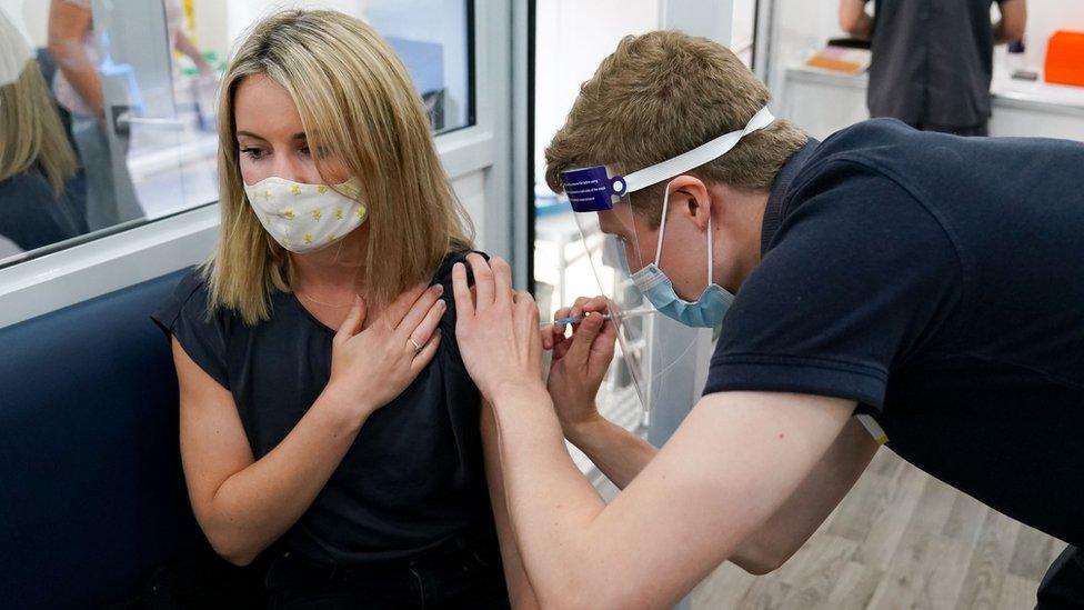 A woman receives a Covid vaccine