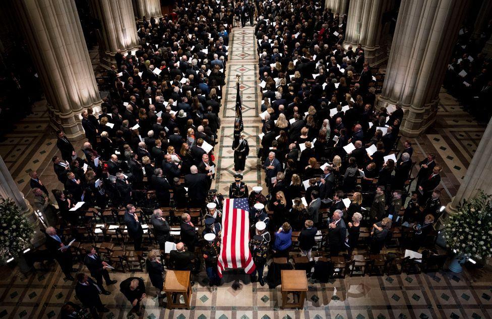 A birds eye view of the congregation and coffin draped in a US flag holding the body of former president George HW Bush.