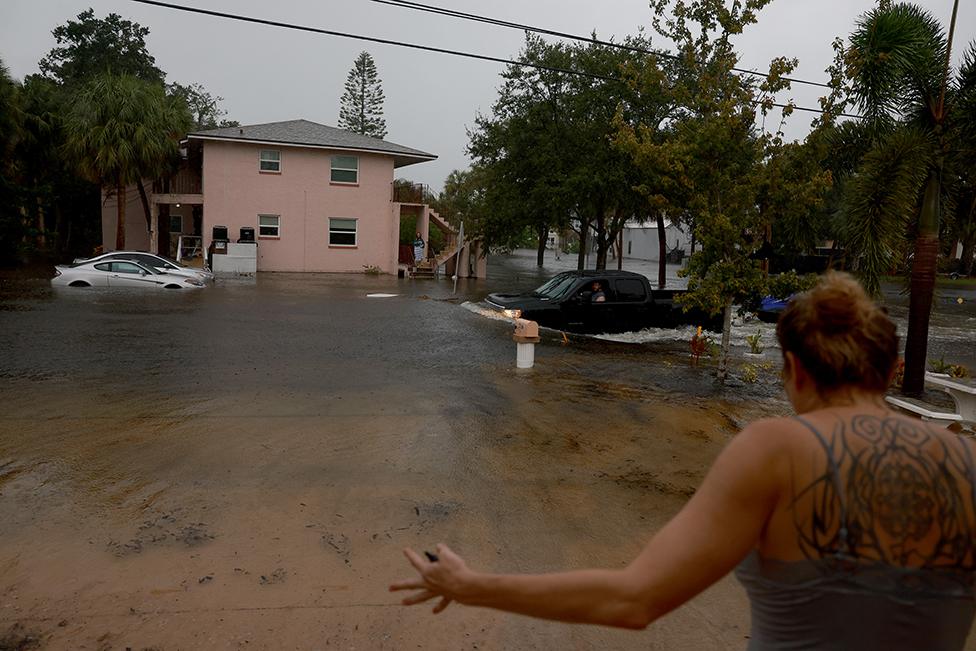 A truck passes through flooded streets caused by Hurricane Idalia passing offshore on 30 August 2023 in Tarpon Springs, Florida