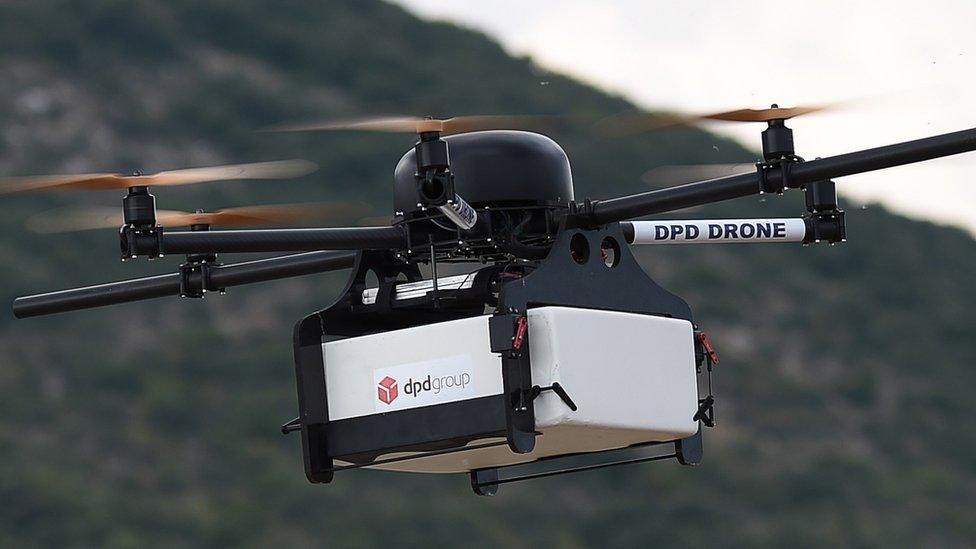 This picture taken on September 28, 2015 shows a Geopost drone flying in Pourrieres, southeastern France, during a presentation of a prototype of a package delivery drone