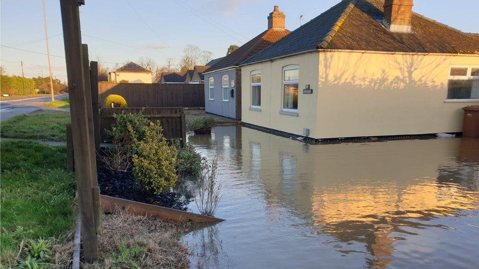 A bungalow surrounded by sewage water