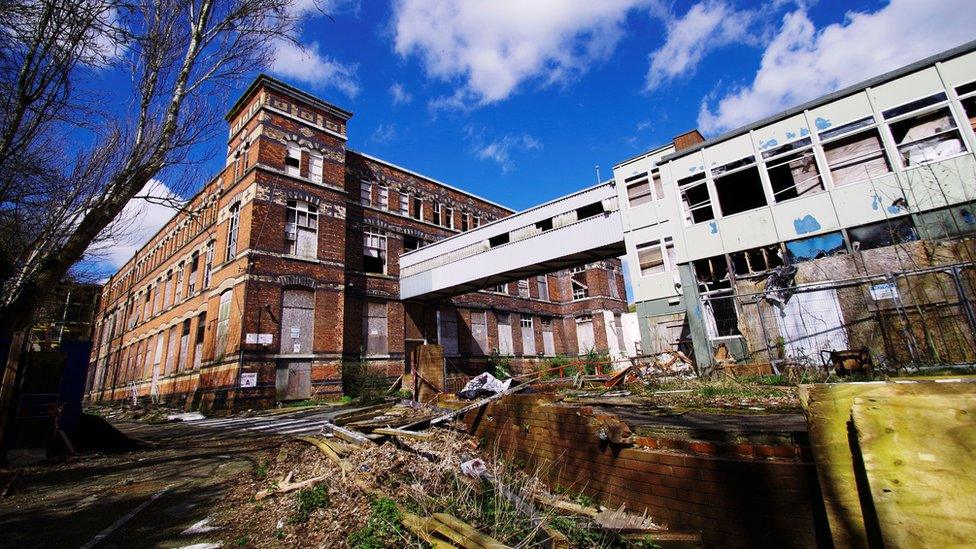 Derelict building with rubble in front