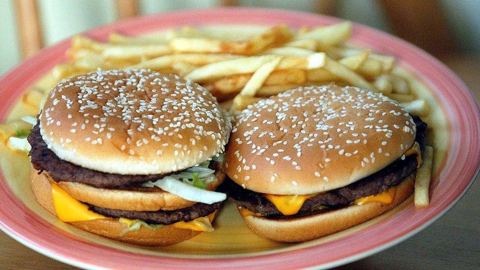 Two burgers and chips on a plate