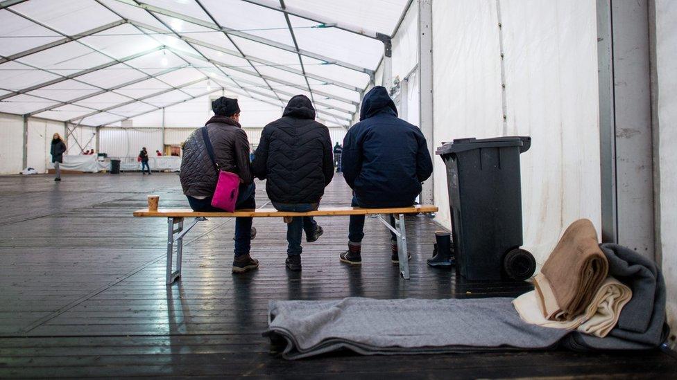 Migrants wait for registration at a temporary camp in Schaerding, Austria