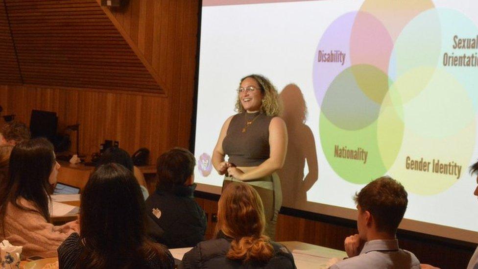 A Bold Voices team member speaking to a group of students