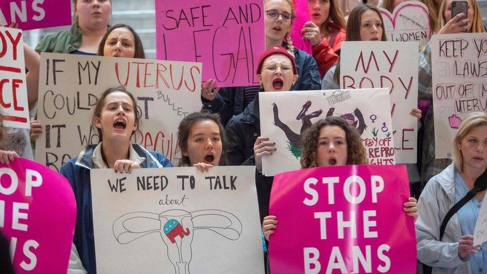 Pro-choice activists hold signs at a rally to oppose abortion bans happening throughout the United States, at the State Capitol Building in Salt Lake City, Utah