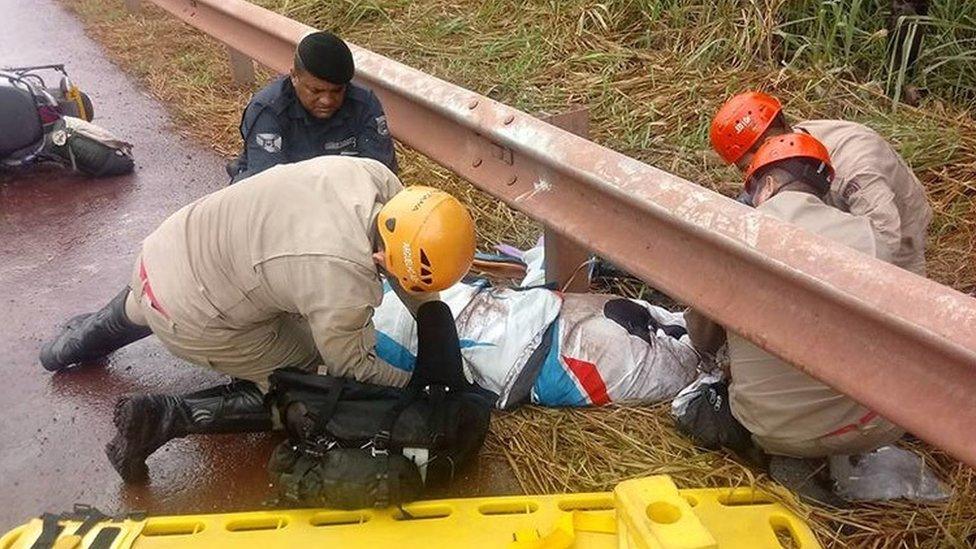 Christopher Peck being tended to by emergency services after the crash