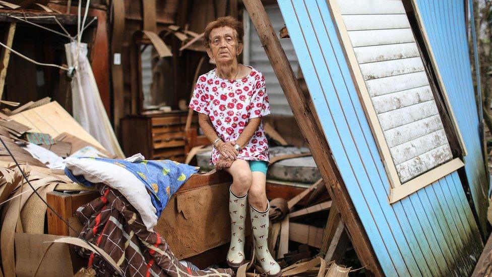 Hurricane victim sits in damaged home