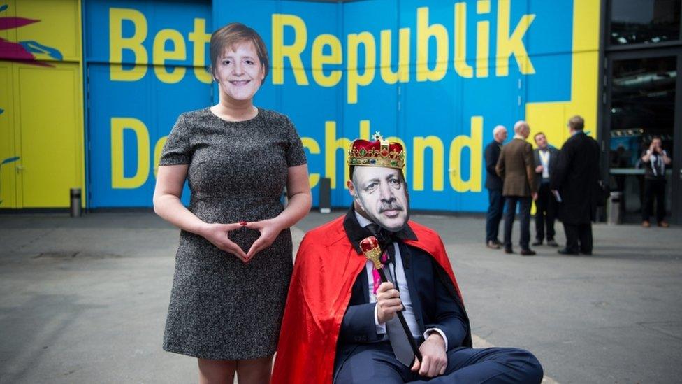 Members of the FDP youth organization Young Liberals pose with the masks of German Chancellor Angela Merkel (L) and Turkish President Erdogan (R) in front of a wall with the party annual congress theme "Beta Republic of Germany", during the party annual congress in Berlin, Germany, 23 April 2016