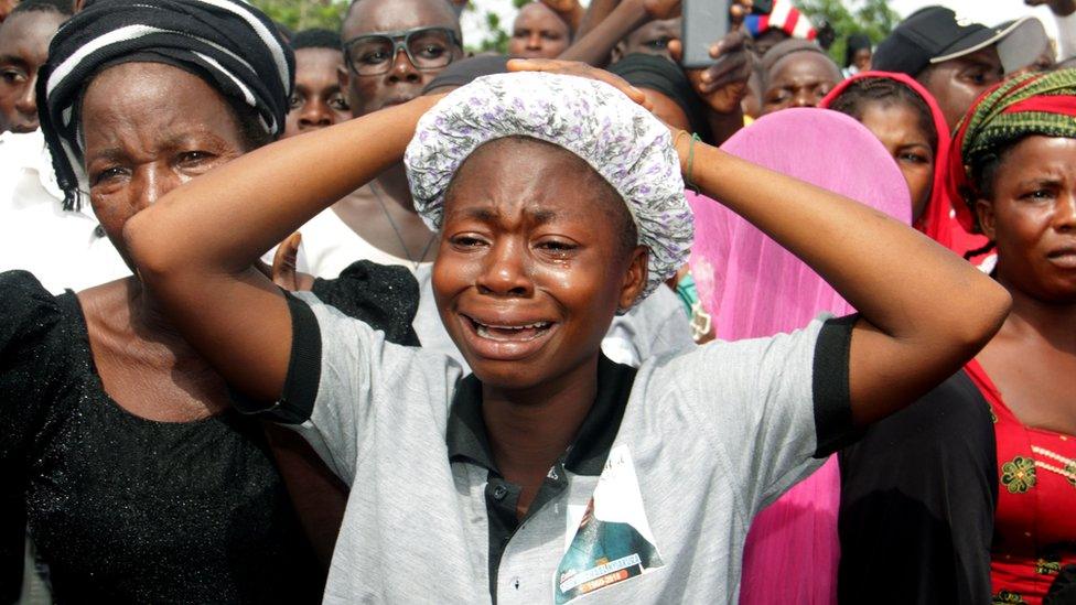 Mourners gather at a funeral service