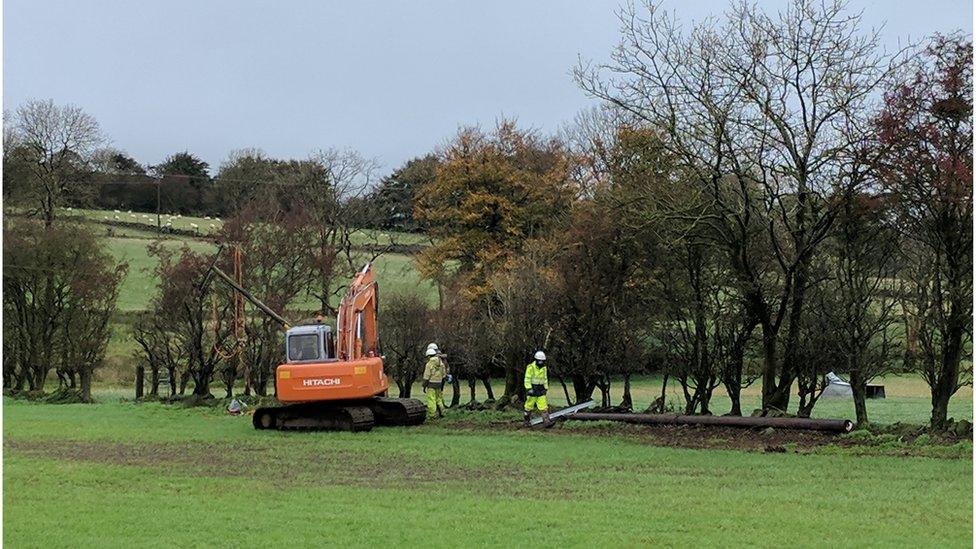 NIE workers undertaking repair work in a field in Doagh