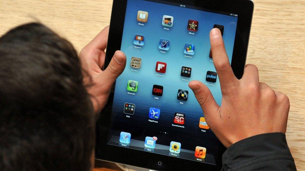 person using an Apple iPad tablet