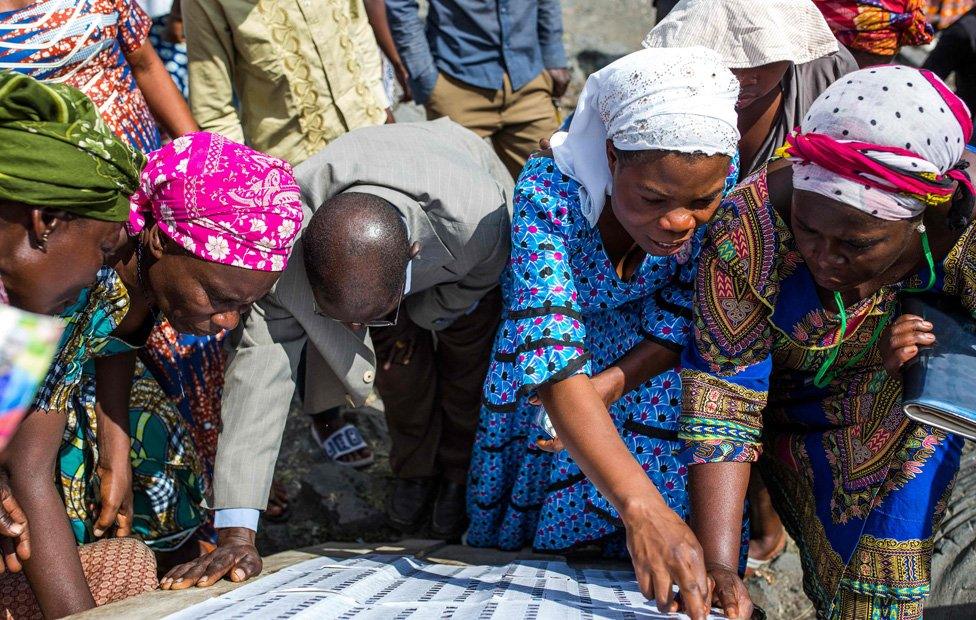 Voters look for their names on the electoral roll outside the Kibancha polling station in Sake, North Kivu, on December 30, 2018.