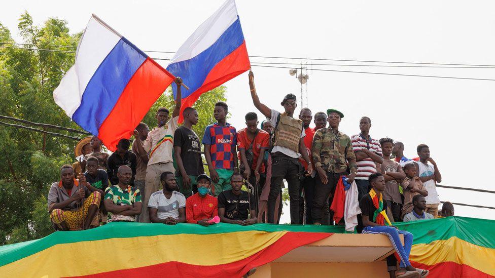 Supporters of Mali's junta wave Russian flags during a pro-Russia rally in Bamako, Mali - May 2022