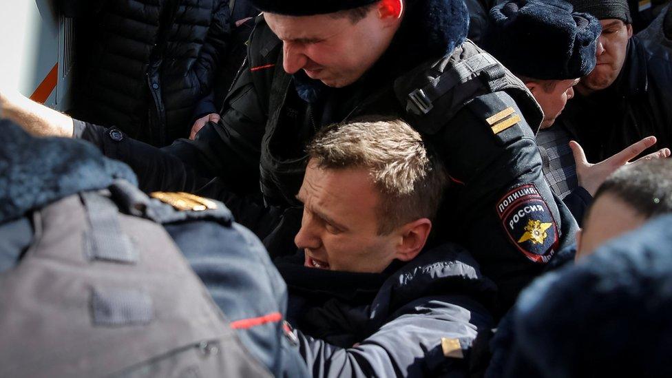 Police officers detain anti-corruption campaigner and opposition figure Alexei Navalny during a rally in Moscow