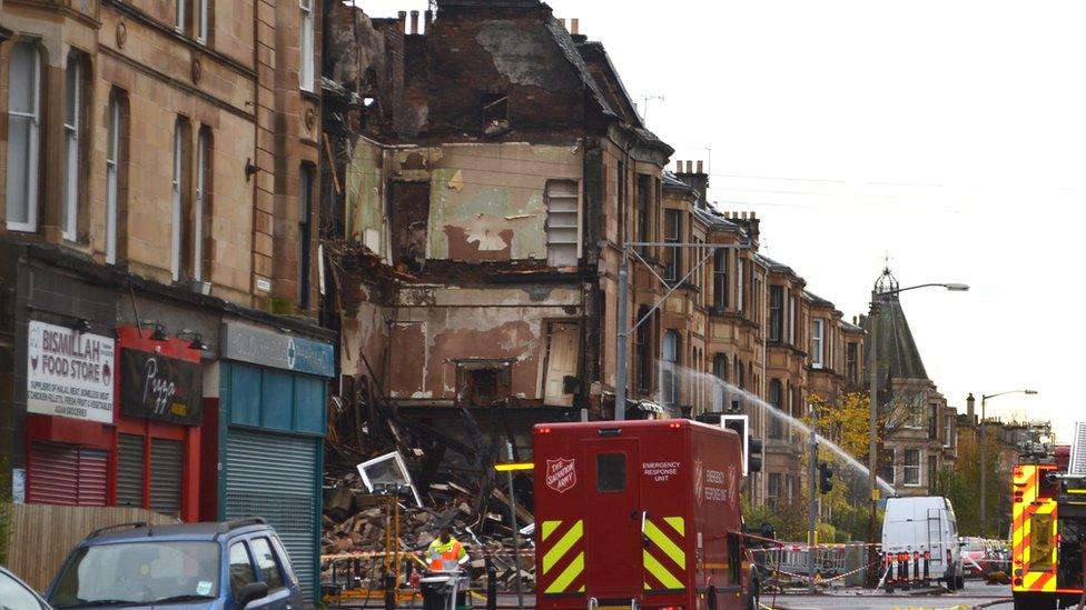 A view of the collapsed building with emergency services foreground