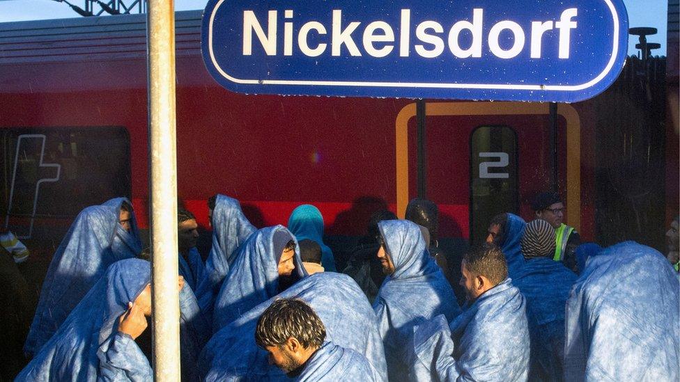 Migrants board a train in the village of Nickelsdorf in early hours on September 5, 2015