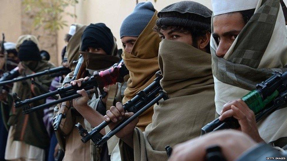 Former Taliban fighters holding weapons before they hand them over as part of a government peace and reconciliation process at a ceremony in Jalalabad (08 February 2015)