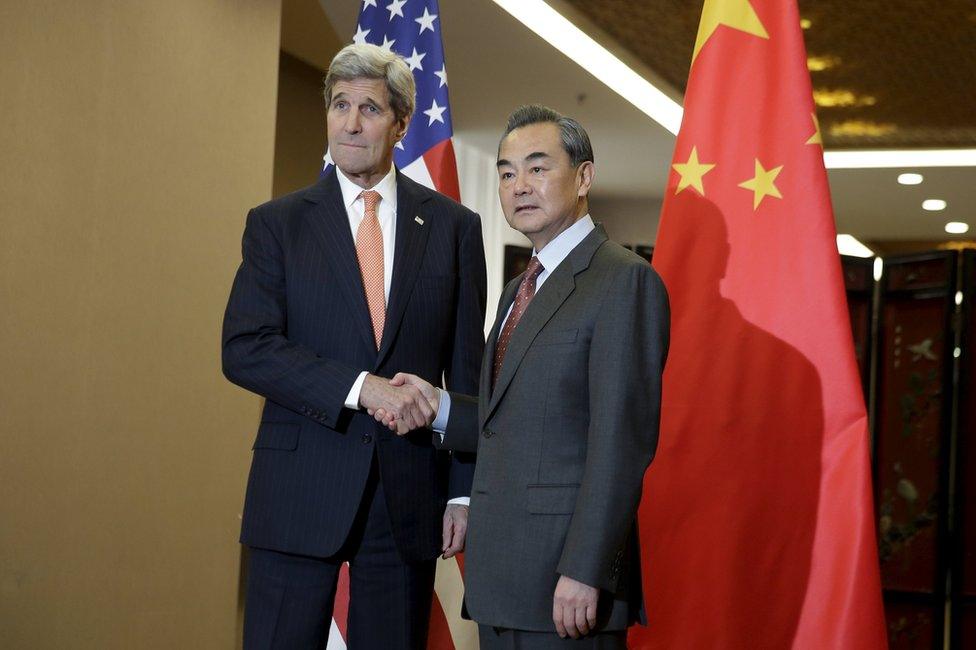 US Secretary of State John Kerry (L) and Chinese Foreign Minister Wang Yi shake hands before their bilateral meeting at the Ministry of Foreign Affairs in Beijing 27 January 2016