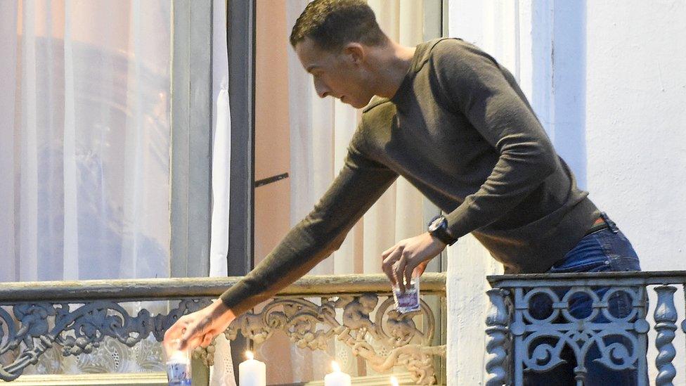 Mohamed Abdeslam, brother of Brahim Abdeslam, lights candles to remember the Paris victims (18 Nov)