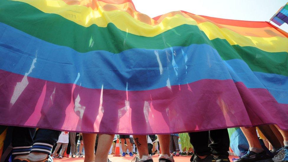 People holding the rainbow flag participate in the color run on May 21, 2017 in Taiyuan, Shanxi Province of China.