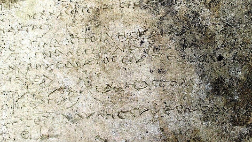 A handout photo made available by the Greek Ministry of Culture shows a clay tablet with an engraved inscription of a rhapsody in Homer's "Odyssey" on 10 July 2018