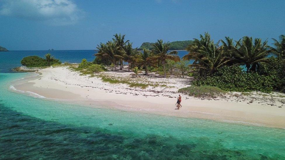 Lynda and Steve Dalgleish walking on Sandy Island near Grenada after swimming ashore