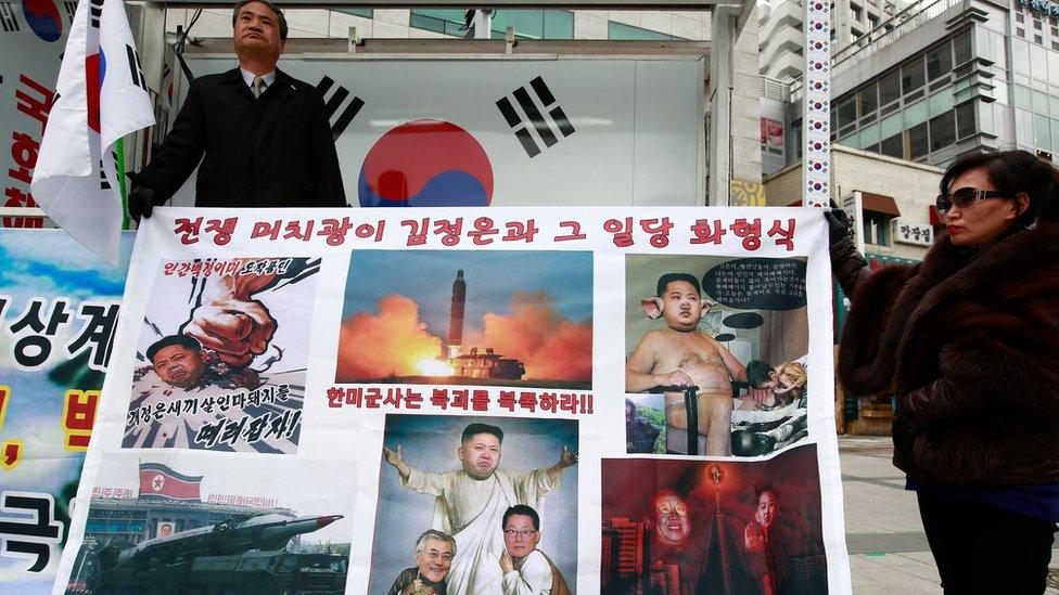 South Korean activists hold a banner depicting Kim Jong-un in various derogatory ways during a rally against North Korea's latest ballistic missiles test. Seoul, South Korea, 8 March 2017.