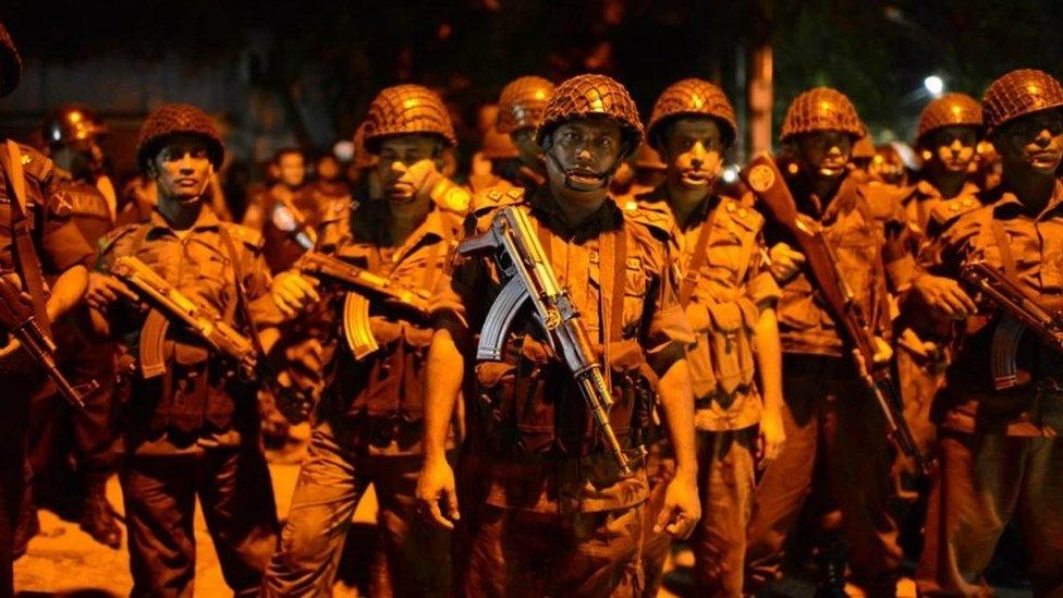 Bangladeshi security forces guard near the restaurant in Dhaka