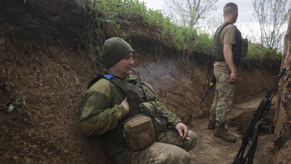 A Ukrainian soldier rests in the eastern Donetsk area, where a Russian offensive is continuing