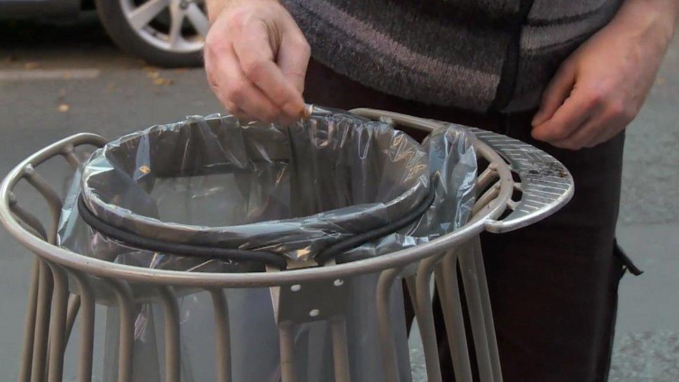 Man throwing cigarette butt in the bin