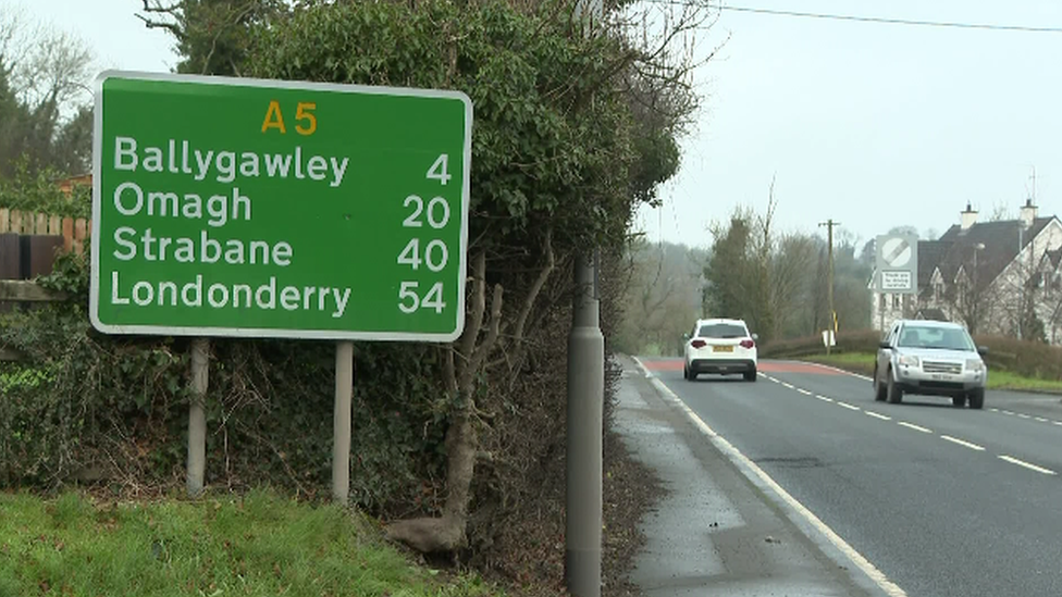 Cars pass a road sign on the A5