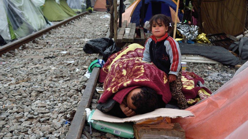 Migrants sleep on rail tracks near Idomeni