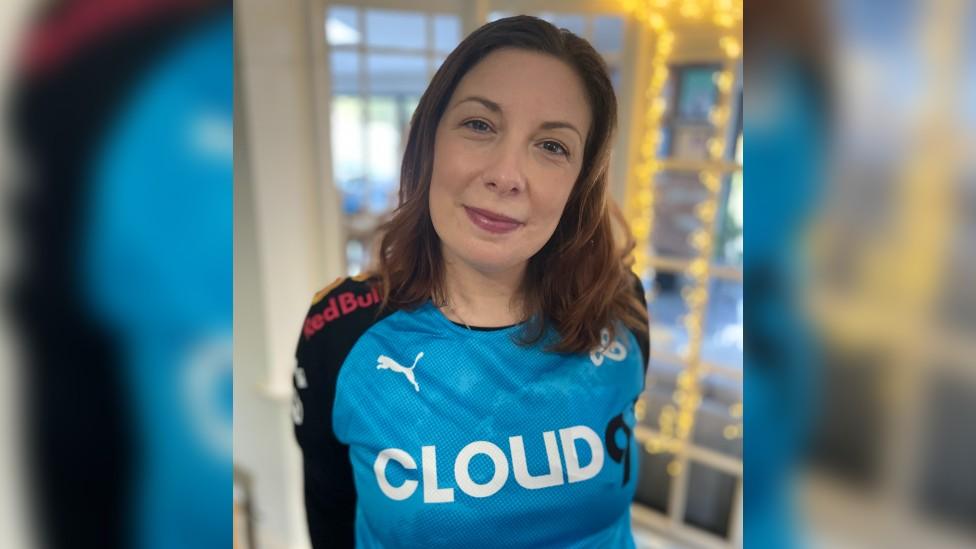 Emily Perkins in Cloud9 merchandise