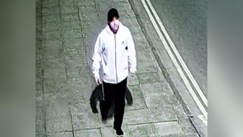 CCTV footage of man in white jacket