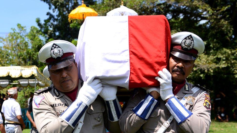 The coffin containing the body of police officer Wayan Sudarsa