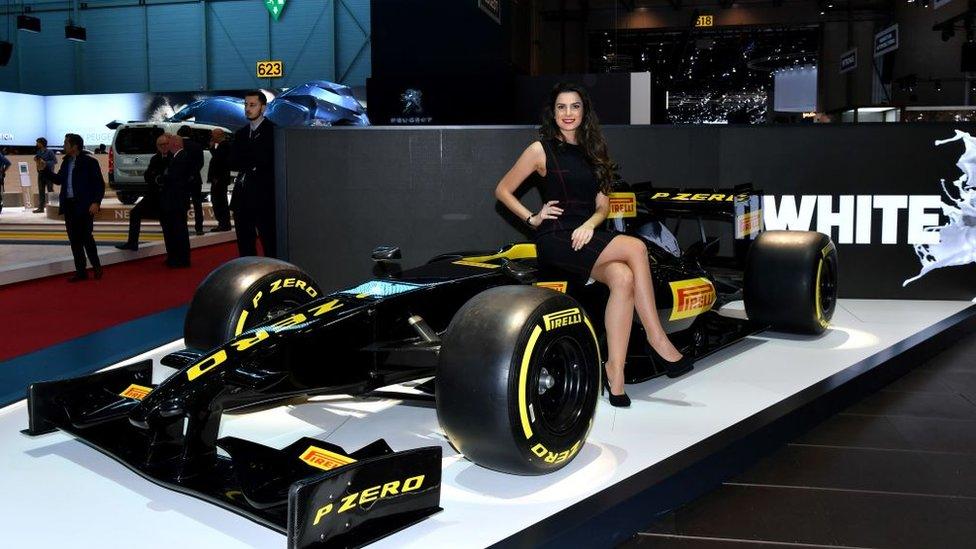 A hostess poses at the Pirelli booth during a press day ahead of the Geneva International Motor Show on March 6, 2018