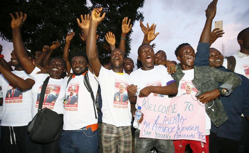 Local Arsenal supporters cheer upon the arrival of Arsene Wenger at the Roberts International Airport in Harbel, Liberia, 22 August 2018